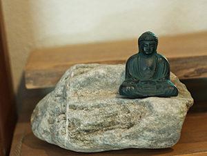 Buddha statue sitting on a rock